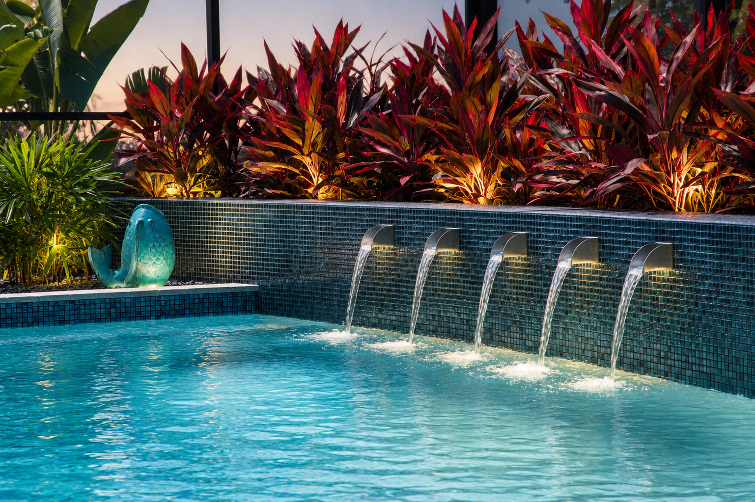 Illuminated water wall with scuppers at dusk, landscape lighting, Naples, Florida