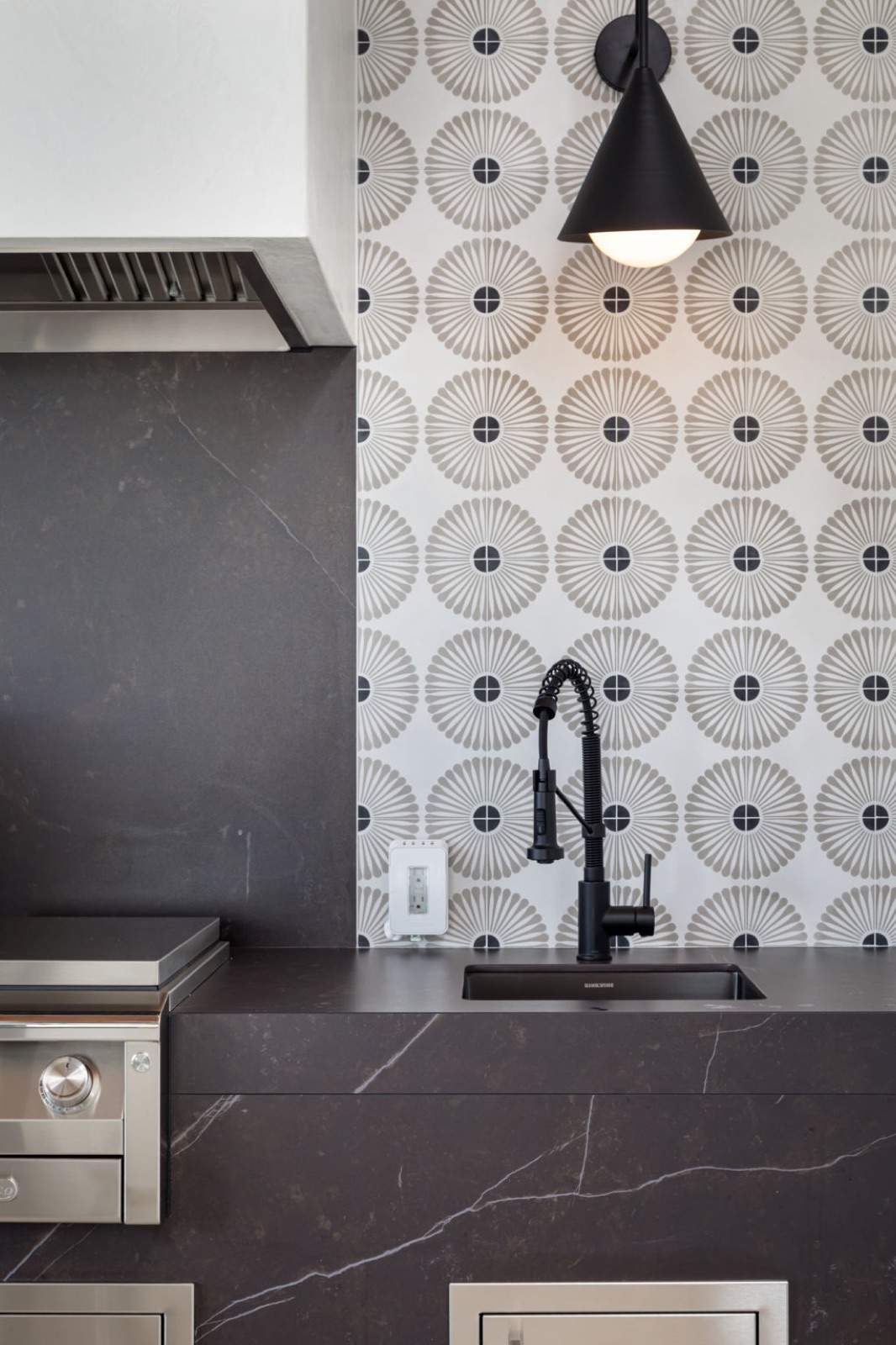 Modern outdoor kitchen detail with custom cabinetry and countertop